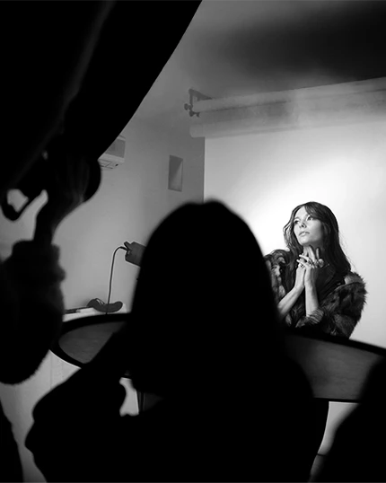 Studenti fotografano la modella che posa in studio.
